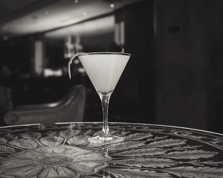 Black And White Photo Of A French Lady Cocktail On A Beautiful Side Table